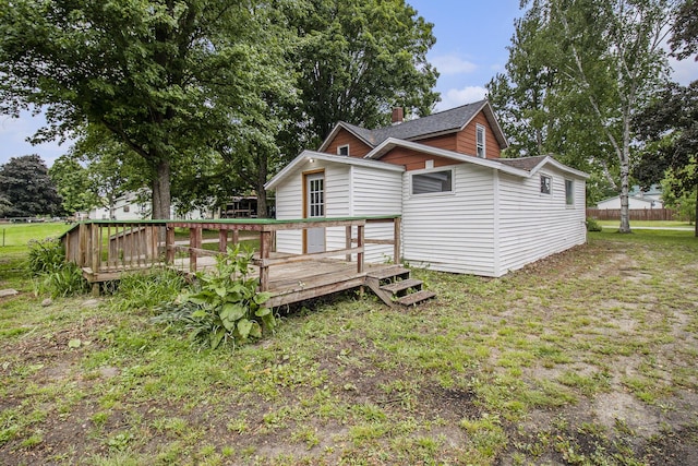 239 Laurel St, Walkerville, MI 49459 - rear view of property with a wooden deck, roof with shingles, and a chimney