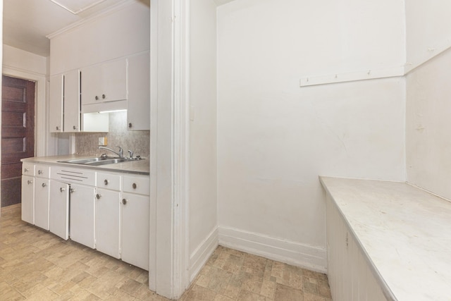 kitchen featuring white cabinetry, sink, and decorative backsplash