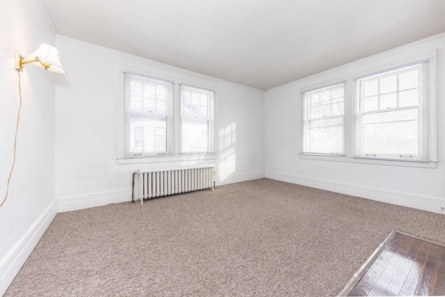 carpeted spare room with radiator