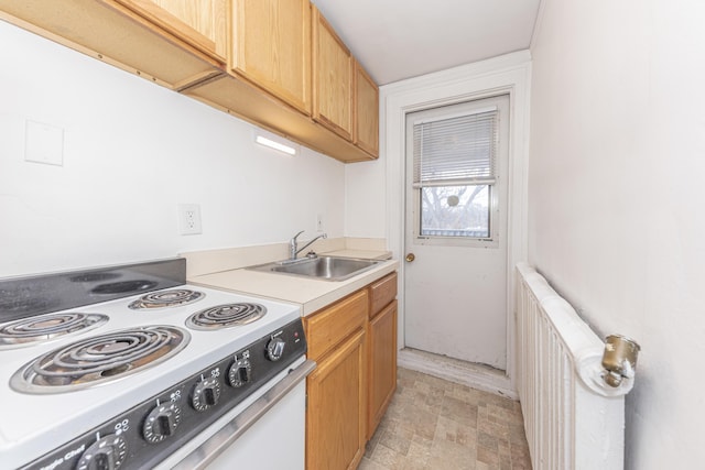 kitchen featuring sink, radiator heating unit, and electric range