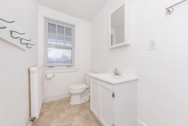 bathroom featuring vanity, radiator, and toilet