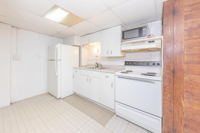 kitchen with sink, white appliances, a paneled ceiling, and white cabinets