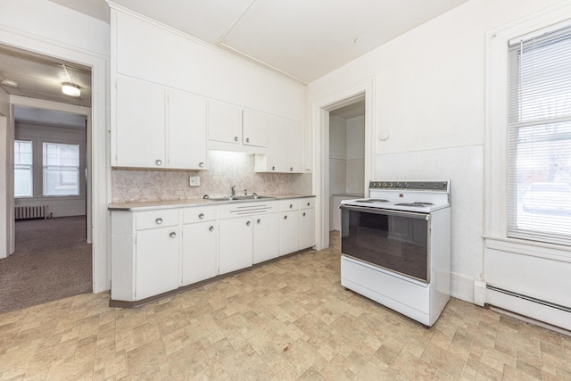 kitchen with radiator, white electric range, white cabinets, and baseboard heating