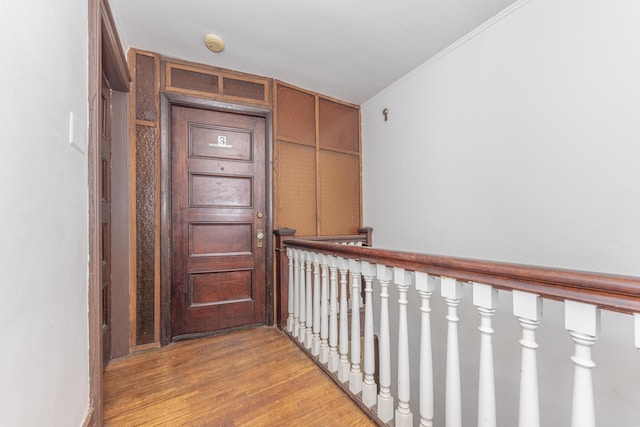 hallway with ornamental molding and light wood-type flooring