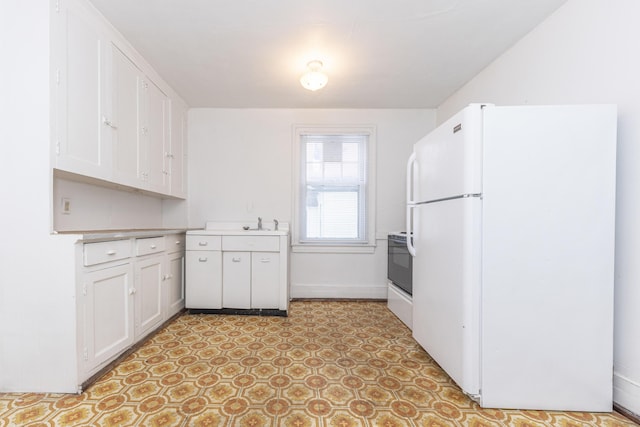 kitchen with white appliances and white cabinets