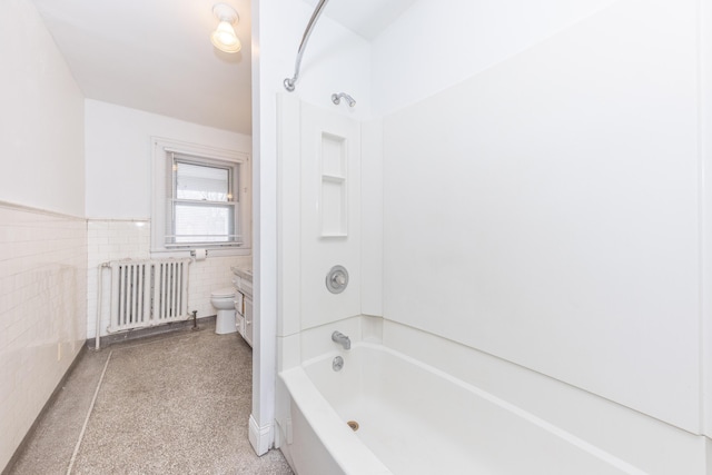 bathroom featuring tub / shower combination, radiator heating unit, tile walls, and toilet