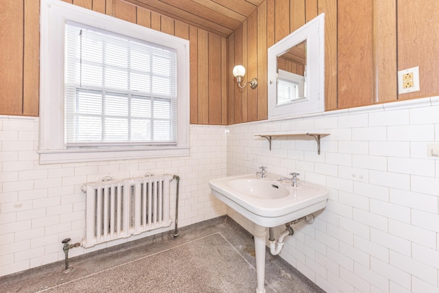 bathroom with radiator and tile walls