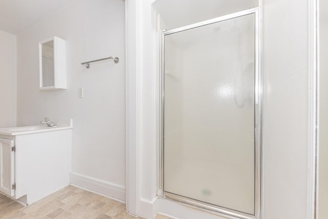 bathroom featuring a shower with door