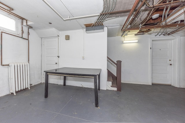 basement featuring radiator heating unit