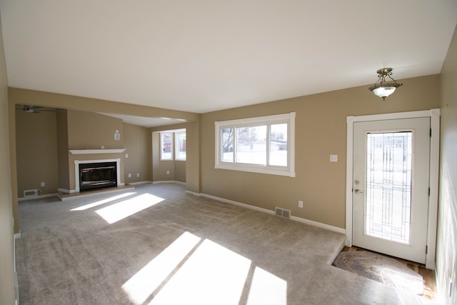 unfurnished living room featuring light carpet