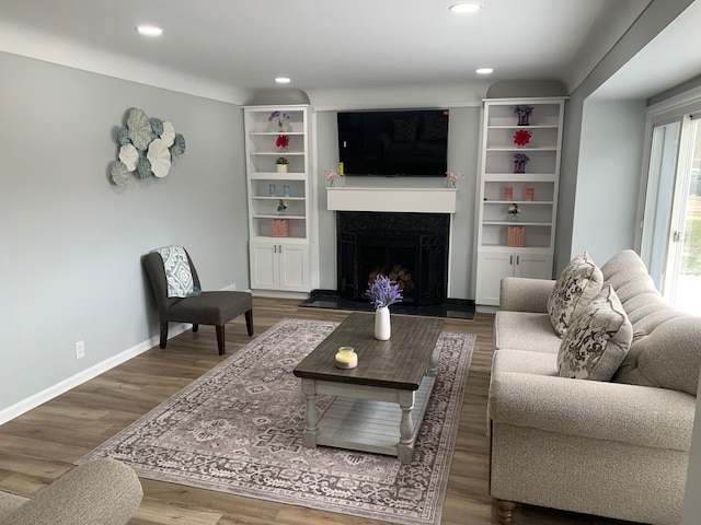 living room featuring hardwood / wood-style flooring and a high end fireplace