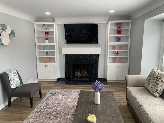 living room featuring hardwood / wood-style flooring and a premium fireplace