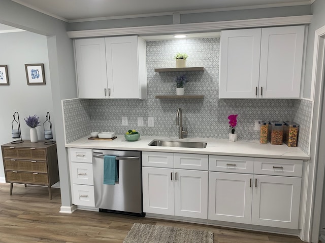 kitchen featuring white cabinetry, dishwasher, sink, dark hardwood / wood-style flooring, and decorative backsplash