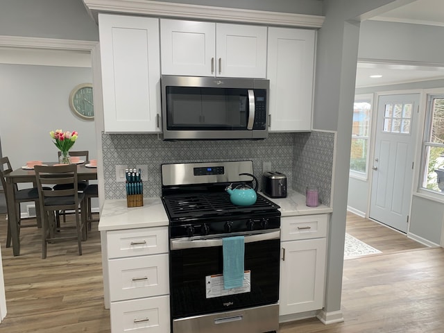 kitchen with white cabinetry, light hardwood / wood-style flooring, and stainless steel appliances