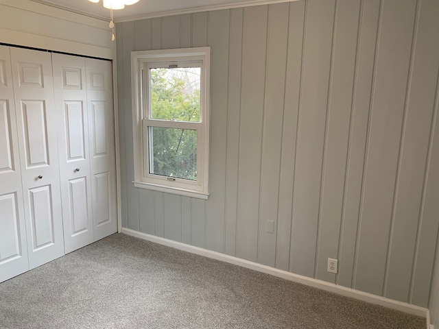 unfurnished bedroom featuring a closet and carpet