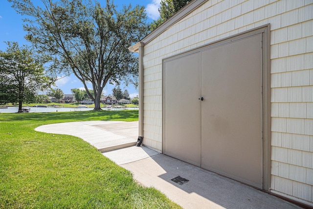 view of outbuilding featuring a yard