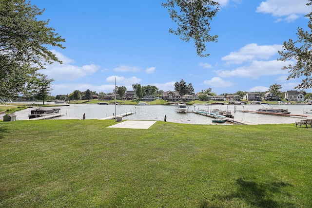 view of yard with a dock and a water view