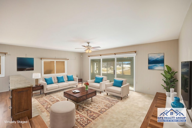 living room featuring ceiling fan and light hardwood / wood-style floors