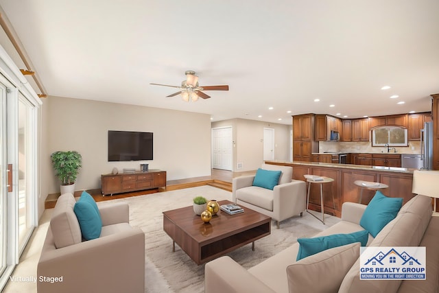 living room featuring sink and ceiling fan