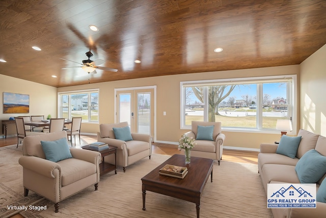 living room with french doors, wood ceiling, a healthy amount of sunlight, and light wood-type flooring