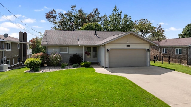 ranch-style home featuring a garage and a front lawn