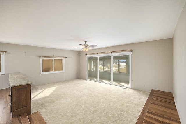 spare room featuring ceiling fan and light carpet