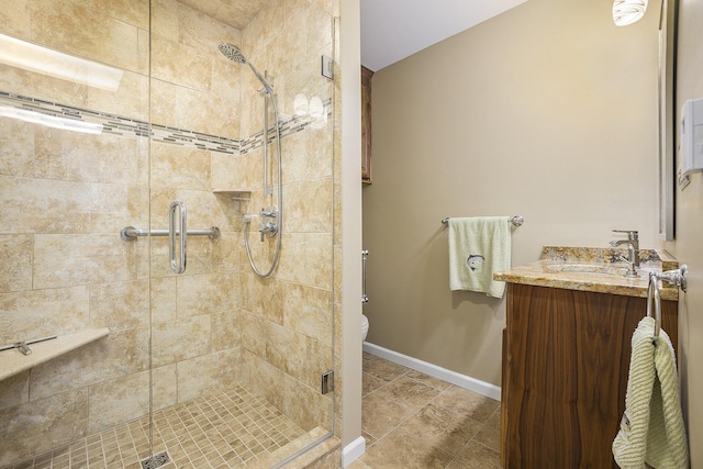 bathroom with vanity, a shower with shower door, and toilet