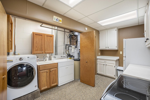 clothes washing area with sink and washing machine and clothes dryer