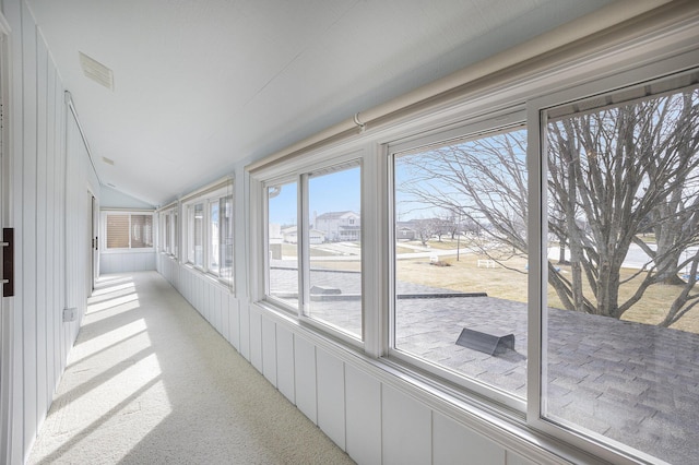 sunroom featuring lofted ceiling