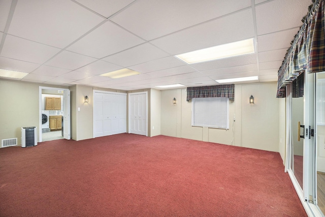 basement featuring washer / clothes dryer, carpet floors, and a drop ceiling