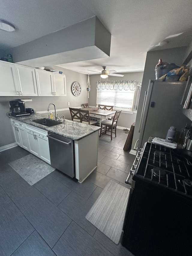 kitchen featuring sink, black range with gas cooktop, light stone counters, white cabinets, and stainless steel dishwasher