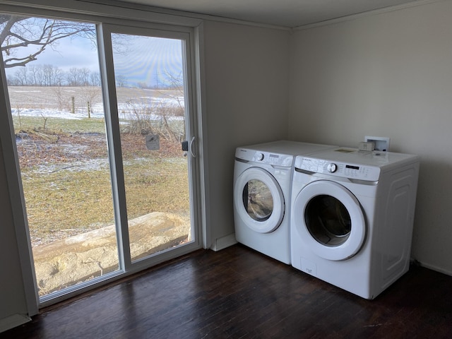 laundry room with dark wood-type flooring, plenty of natural light, and washing machine and dryer