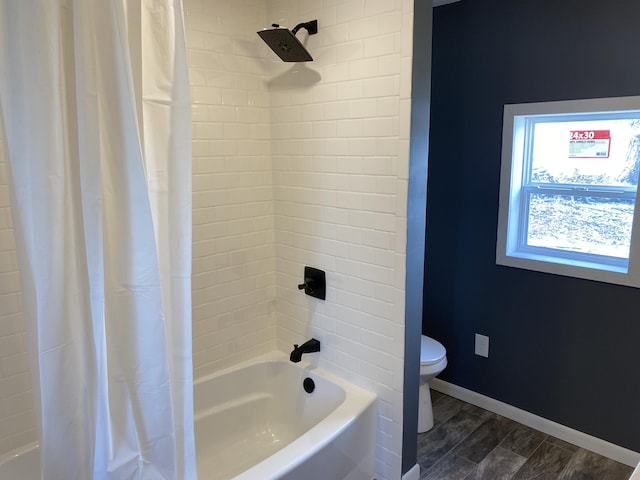 bathroom with toilet, hardwood / wood-style floors, and shower / bath combo