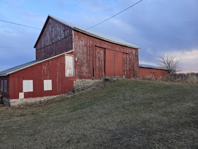 view of outbuilding with a lawn