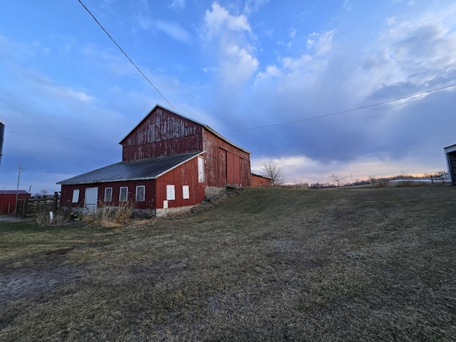 view of side of property with a yard and an outdoor structure