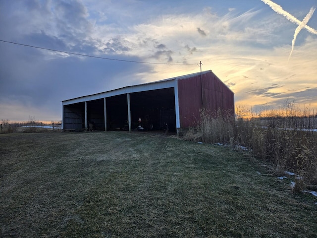 outdoor structure at dusk with a lawn