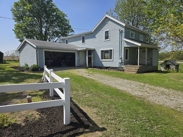 119 W Pearl Rd, Coldwater, MI 49036 - traditional-style house with dirt driveway, an attached garage, a front lawn, and covered porch