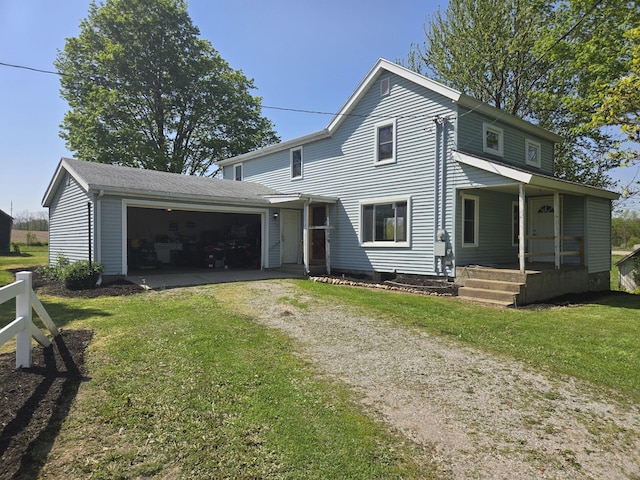119 W Pearl Rd, Coldwater, MI 49036 - view of front of property featuring a porch, driveway, a garage, and a front yard