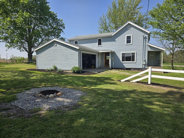 119 W Pearl Rd, Coldwater, MI 49036 - back of property featuring a fire pit, a yard, and a garage