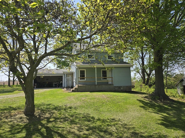 119 W Pearl Rd, Coldwater, MI 49036 - view of front of property with a garage, a front lawn, and a porch