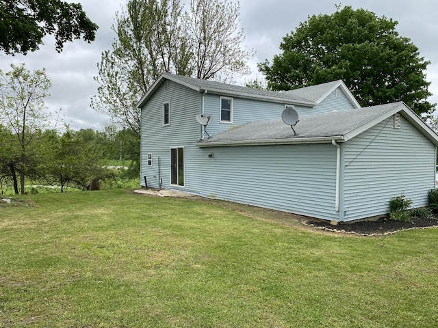 119 W Pearl Rd, Coldwater, MI 49036 - back of house with a lawn and a shingled roof