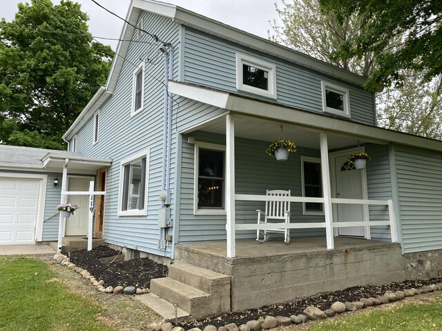 119 W Pearl Rd, Coldwater, MI 49036 - view of front of property with a porch and an attached garage