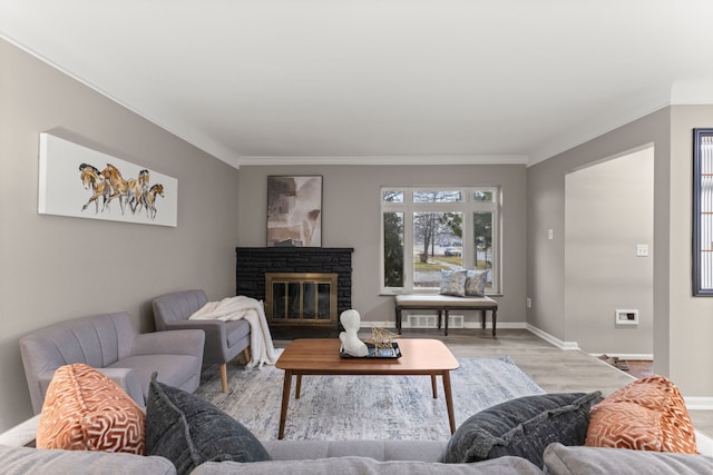 living room with crown molding and wood-type flooring