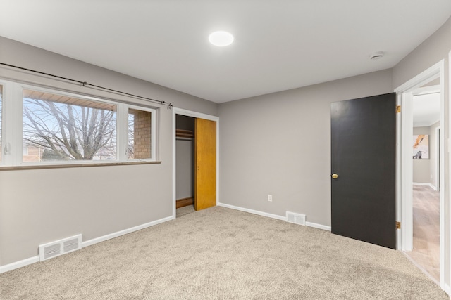 unfurnished bedroom featuring carpet floors and a closet