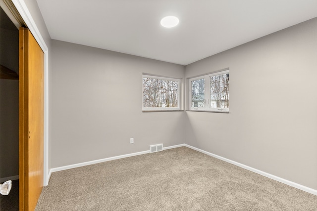 unfurnished bedroom featuring carpet floors and a closet