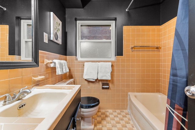 full bathroom featuring tile walls, vanity, tub / shower combination, and toilet