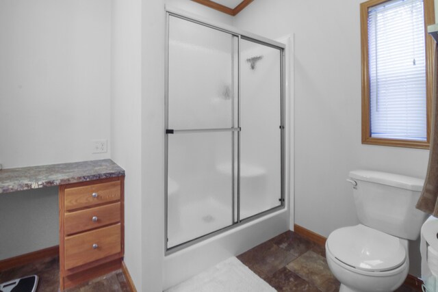 bathroom featuring vanity, an enclosed shower, and toilet