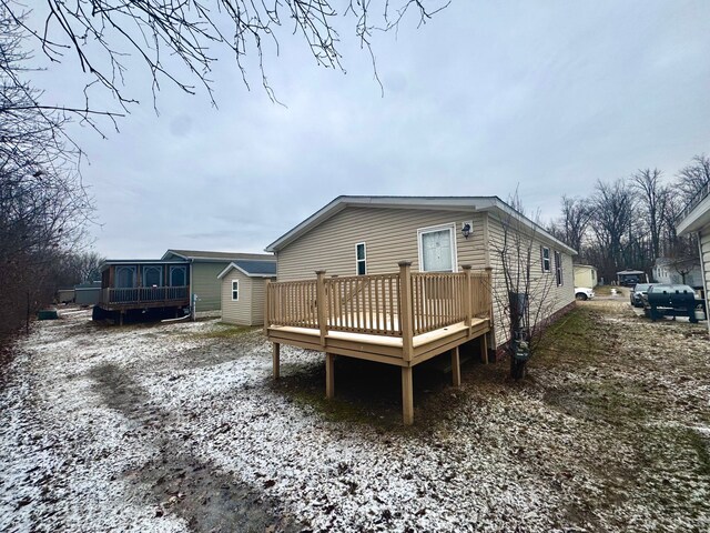 back of property featuring a wooden deck