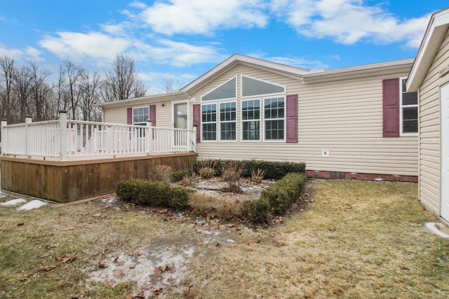 exterior space featuring a deck and a front lawn