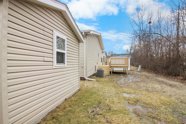 view of yard featuring central AC and a deck